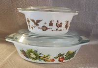 Both covered casseroles stacked, showing patterns and lids