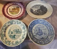 Front view of the four decorative plates showing colors and scenes