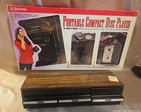 Boxed Emerson AD2528 portable CD player above Futura six-drawer storage unit