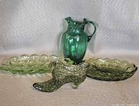 All four green glass pieces grouped: hobnail shoe, pitcher, leaf dish, oval dish