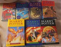 All seven Harry Potter paperback books laid out front covers visible