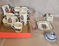 Group shot of all items including playing card cups/saucers, oil lamp, lighter, plate, condiment holder, shakers, horse figurine