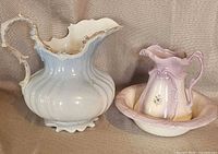 large and small pitchers with basin grouped