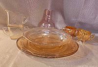 Group shot of all seven pink iridescent Depression glass pieces