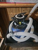 Top view of Dacom filter tank with multi-port valve and attached hoses