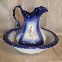 Pitcher seated in basin, showing colour gradient, relief details and floral decal