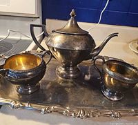 Full view of teapot, creamer, sugar bowl on tray