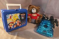 Group shot of lunchbox, bear, car
