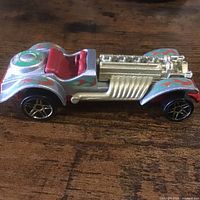 Side profile of silver Sweet 16 with red interior and gold engine