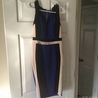 Front view of sleeveless color-block dress hanging on hanger