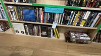 Wide view of two shelves filled with documentary DVDs