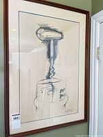 Full view of framed corkscrew sketch on wall