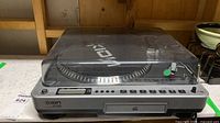ION LP2CD USB turntable with dust cover closed showing CD tray and control panel