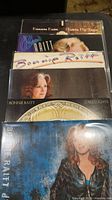 Stack of six Bonnie Raitt vinyl albums showing covers of five identifiable titles