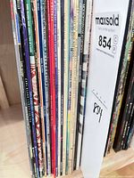 Spines of approximately 25 jazz LPs on shelf