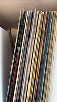 Stack of LP records showing spines with artist names