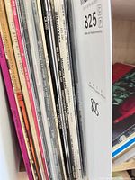 Stack of record album spines showing various titles and artists