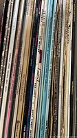 Row of vinyl LP spines showing variety of albums