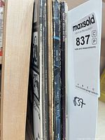 Spine view of seven record albums on shelf