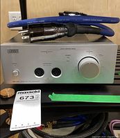 Front view of Stax SRM-700S showing outputs, controls, Cardas cable on top