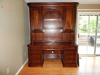 Front view of desk with hutch showing dovetail drawers, storage cabinet, and arch detail on hutch