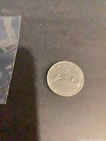 Full view of coin on dark background