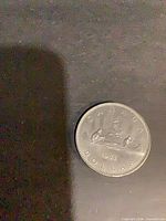 1981 Canadian dollar reverse showing Voyageur canoe design