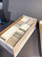 Top view of open long cardboard box filled with two rows of hockey trading cards