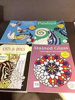 Top view of all four coloring books laid out