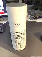 Front view of white Amazon Echo speaker with lot sticker