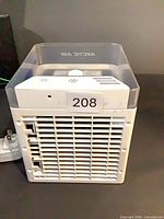Front view of Arctic Air cooler showing grille and clear top