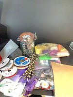 overview of lot with jar of buttons, yarn, ribbon spools, paper straws, bags of embellishments