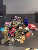 Pile of mixed keychains on surface