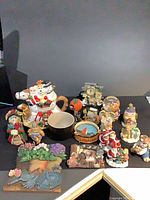 Full group of figurines, pitcher, mug, snow globe, clocks and plaques
