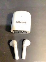Earbuds and charging case front view