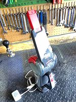 Full view of Black & Decker Pivot cordless handheld vacuum on charging base with power adapter