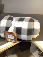 Rolled fleece throw with bow and tag visible