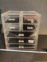 Front view of clear acrylic organizer showing six drawers and handles