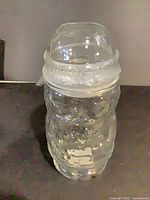 front view of clear glass Santa cookie jar with lid