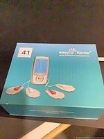 Front of turquoise easy@Home Mini Electronic Pulse Stimulator box showing product image