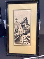Full view of framed etching showing image, mat, and black frame