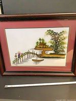 Front view of framed embroidered landscape art showing full design and frame