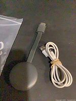 Chromecast with HDMI lead and USB power cable, overhead view