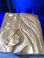 Front view of entire carved plaque with mother and child design