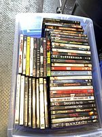 Top view of plastic tote showing rows of DVD spines