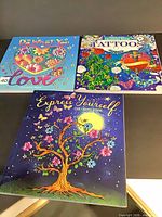 Front covers of the three coloring books