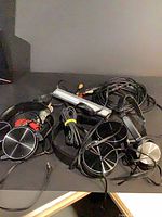 Group of headphones and cables on tabletop