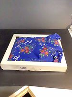 Magic Bag blue floral heat pad folded in white box, lot sticker visible