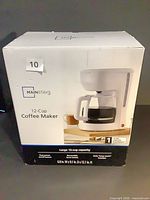 Front of sealed Mainstays 12-cup coffee maker box
