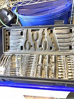 open case showing top tray with wrenches, pliers, hex keys and bits
